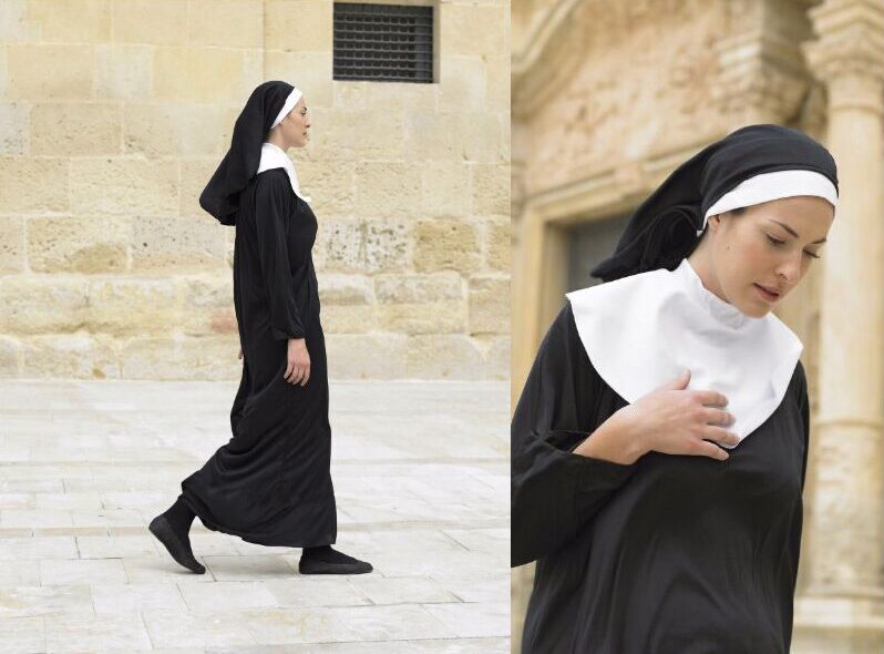 Young nun walking then looking down